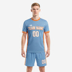 Custom sky blue and orange futbol uniform with honeycomb sublimation and orange side panels, front view