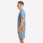 Sublimated sky blue orange soccer uniform right side view with striped sleeve cuffs and matching shorts
