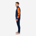 Right side view of navy and orange soccer training tracksuit showing full raglan sleeve splash graphic and matching tapered pants