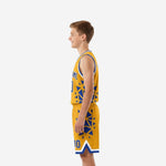 Side view of gold and royal blue youth basketball uniform showing starburst pattern wrapping from jersey side panel down through matching shorts leg
