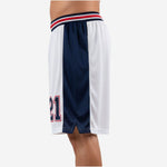 Side view of navy side-panel basketball shorts showing wide sublimated panel and hem split detail