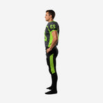 Side panel detail of charcoal football jersey with curved lime green shoulder and chest panel and matching lime green thigh panel on black pants