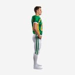 Custom green and gold American football uniform jersey with gold shoulder panels white cuff trim and bold front number worn by male athlete