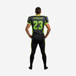 Opposite side view of lime green and charcoal custom football uniform showing full-length pants with outer lime green side stripe