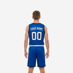Right side view of custom sublimated basketball uniform in royal blue showing matching white side panel on shorts and navy hem binding
