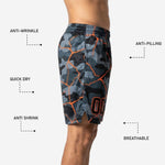 Close detail of sublimated player number on the lower left leg panel of grey camo basketball shorts with orange print