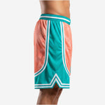 Front view of custom sublimated basketball shorts showing teal waistband with white stripe, coral center panel, and teal retro arc hem detail