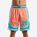 Sublimated basketball shorts in teal and coral with palm-leaf front panel, retro arc hem, and player number 28 on front thigh