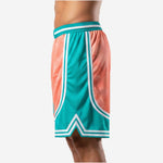 Side view of sublimated basketball shorts showing teal side panel with double white stripe trim and side split at hem