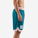 Side view of sublimated basketball shorts in teal with coral and white double-chevron hem and striped elastic waistband, number 00 on thigh