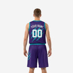 Second side view of purple teal basketball uniform packages highlighting teal claw-scratch graphic on shorts right panel