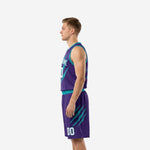 Side view of purple and teal sublimated basketball uniform packages showing V-neck binding and matching shorts waistband
