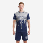 Sublimated blue and white soccer uniform with silver splash chest graphic and matching navy shorts, front view on male model