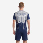 Custom sublimated soccer jersey detail showing silver upper chest transition to navy blue body with drip splash print