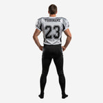 Matching team football uniform back view showing back number placement, player nameplate area, and full-length black tackle pants with grey leg stripe