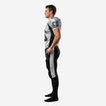 Personalized american football uniform side view showing black side panels on white jersey body and silver-grey pant stripe running hip to ankle