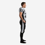 Black and white sublimated football uniform sets - side view showing black shoulder panel, sleeve number 23, and silver-grey outer leg stripe on black pants