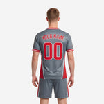 Close detail of sublimated grey soccer jersey with diagonal cross-hatch texture and red curved panel