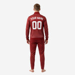 Sublimated red soccer tracksuit jacket detail showing dot-burst pattern fading from crimson at shoulders to deep maroon at hem