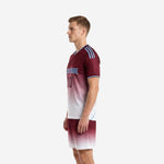 Sublimated red soccer uniform opposite side view displaying sky blue shoulder stripes and matching maroon-to-white gradient shorts