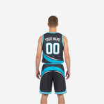 Side view of charcoal and teal reversible basketball jersey showing armhole binding and sweeping panel from the side angle