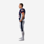 Navy and white custom football uniform opposite side view showing curved jersey side panel and matching pant leg stripe alignment on adult male player