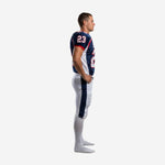 Custom navy and white tackle football uniform side view showing set-in sleeve with shoulder number, red cuff trim, and wide navy outer leg stripe on white football pants