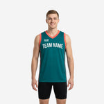 Custom teal basketball jerseys with coral V-neck and side-panel trim, team name arched across the chest, front and back view on male model