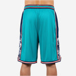Right side view of custom teal basketball shorts displaying pink border stripe running from elastic waistband to hem notch