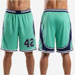 Detail view of teal basketball shorts showing the elastic waistband with navy and white stripe bands and internal drawcord