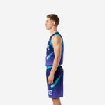 Side view of custom teal basketball uniform set showing comet streak graphic sweeping across jersey side and down left shorts leg