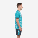 Side view of teal sublimated soccer uniform with charcoal shorts and chevron accent panels