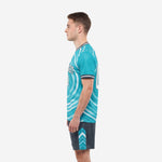 Right side view of teal ripple wave soccer kit showing full sublimation and charcoal shorts detail