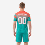 Close up of coral and teal geometric triangle pattern on custom soccer jersey
