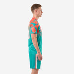 Teal and coral sublimated soccer kits side view showing geometric pattern and shorts stripe