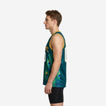 Side view of teal green and gold basketball jersey showing continuous peacock feather print wrapping from front panel around the side