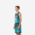 Side view of teal and charcoal gradient youth basketball uniform showing flat armhole binding and elastic waistband on shorts
