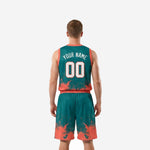 Opposite side view of teal and orange basketball tournament uniform set highlighting splash pattern continuity across jersey hem and shorts leg