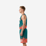 Side view of teal and coral orange sublimated basketball uniform showing armhole binding detail and shorts waistband on adult male model