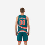 Side view of teal and orange reversible basketball uniform showing armhole binding and shorts side panel on the teal side
