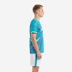 Custom teal soccer uniform kit side view showing hot pink and violet starburst lines on jersey