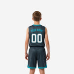 Back view of charcoal youth basketball jersey showing player name and back number in white with teal outline above matching charcoal shorts