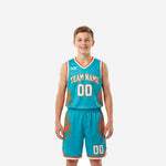 Teal youth basketball uniforms front and back view showing orange geometric shard pattern, V-neck jersey, and matching shorts with white trim