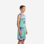 Front view of custom teal and purple youth basketball uniform set showing arced team name and front number on jersey and matching shorts
