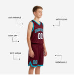 Back view of custom maroon and teal youth basketball uniform showing back number and player name print zones on the jersey