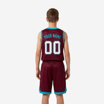Opposite side view of maroon and teal youth basketball uniform set showing shorts teal hem band and leg-split accent detail