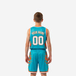 Opposite side view of teal and orange youth basketball uniform showing consistent geometric shard sublimation on jersey and shorts
