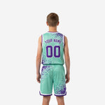 Opposite side view of teal and purple custom youth basketball uniforms showing elastic waistband drawcord shorts and armhole binding detail