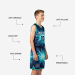 Detail of teal youth basketball shorts showing starburst print, player number at thigh, and teal leg-hem trim band