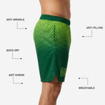 Close detail of lime yellow hexagon fade gradient on forest green custom basketball shorts showing sublimated print quality